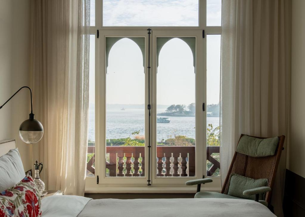 a bedroom with a window with a view of the ocean at Hovagimyan Hotel and Suites in Istanbul