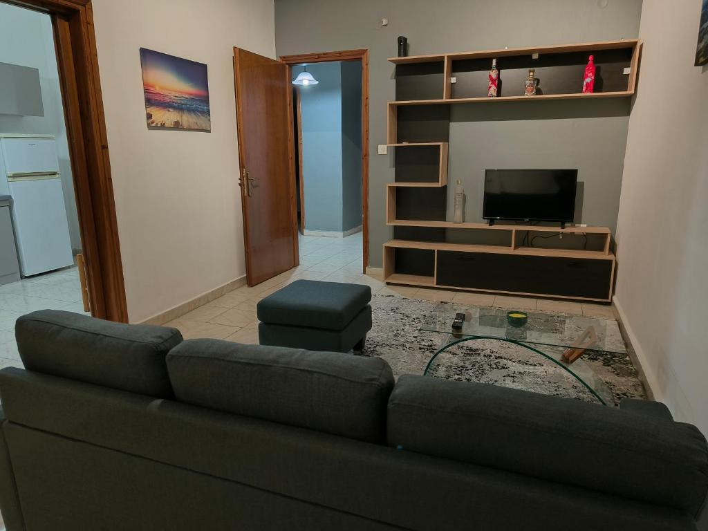 a living room with a couch and a tv at Magda's apartments in Perea