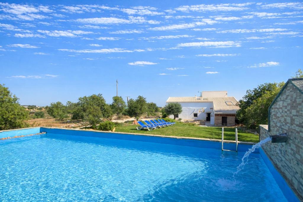 a large swimming pool in front of a house at Gold - Private Pool - 18 Guests - Albufeira in Albufeira
