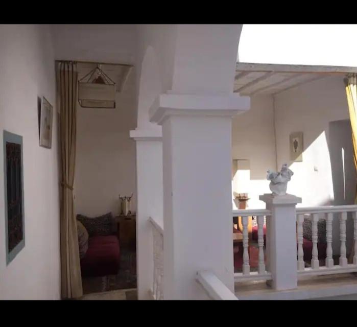a living room with a staircase and a mirror at RIAD Adam in Sidi Ifni