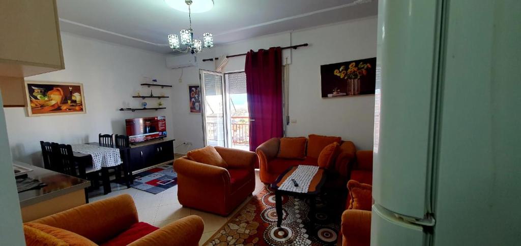 a living room with two couches and a table at Apartament martin 3 in Vlorë