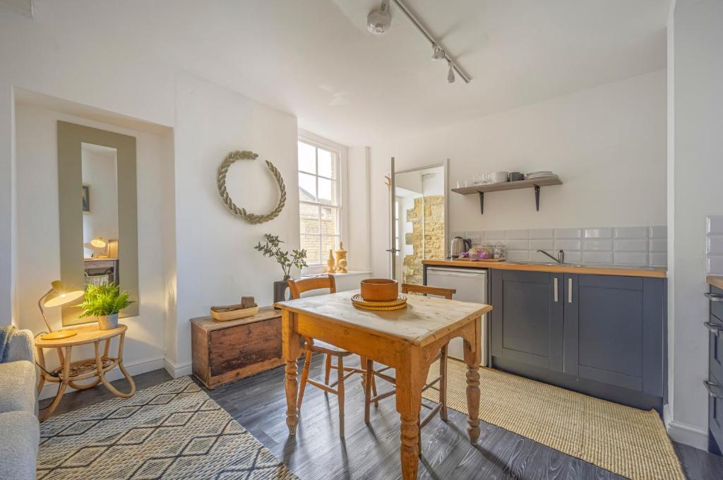 a kitchen with a wooden table in a room at New The Barley Rustic luxury in Cirencester