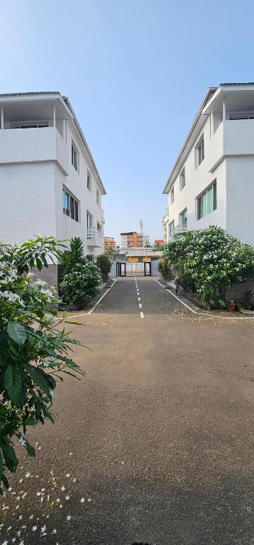 an empty parking lot in front of two buildings at Square Resident in Monrovia