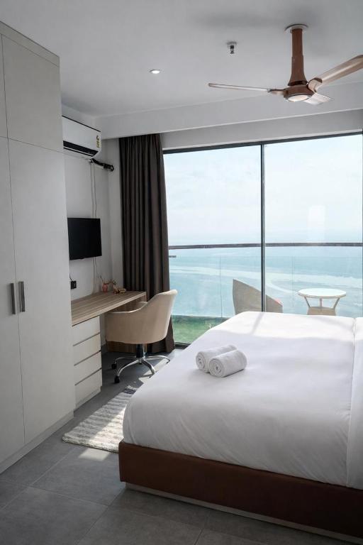 a bedroom with a bed and a view of the ocean at Yamunaviewnest in Noida
