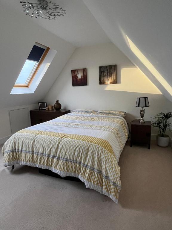 a bedroom with a bed in a attic at Modern Private Rooms in Chelmsford with Workspace & Free Parking in Chelmsford