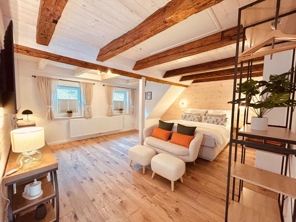 a large bedroom with a bed and a couch at Chalet Lilienstein, Dachgeschoß-Studio neu 2026 in Königstein an der Elbe