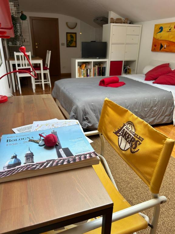 a room with two beds and a table with a laptop on a chair at A Modo Mio - Monolocale - Zona Stadio Ospedale Maggiore in Bologna