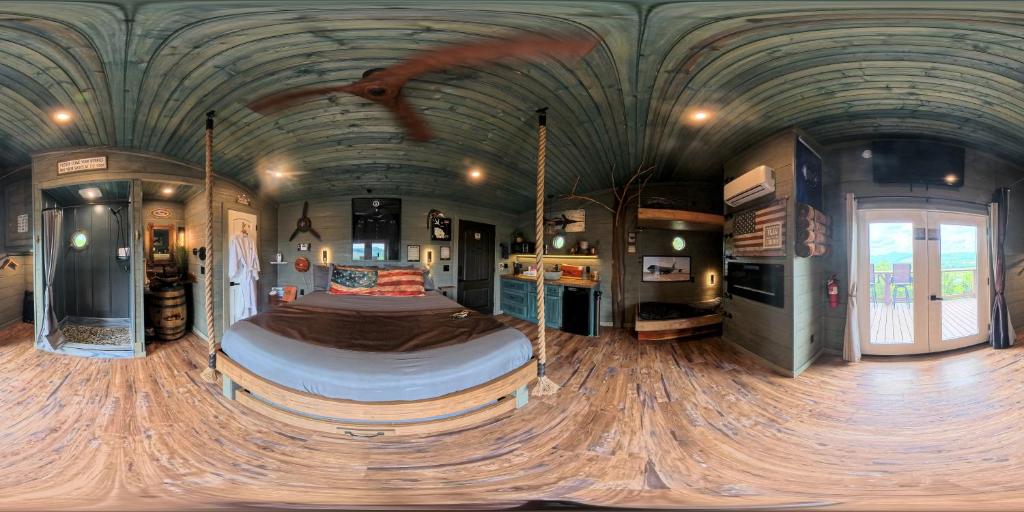 a bedroom with a large bed in a room with a ceiling at "Air Fort One" Aviation-Themed Luxury Treehouse Near Dollywood & Pigeon Forge in Sevierville