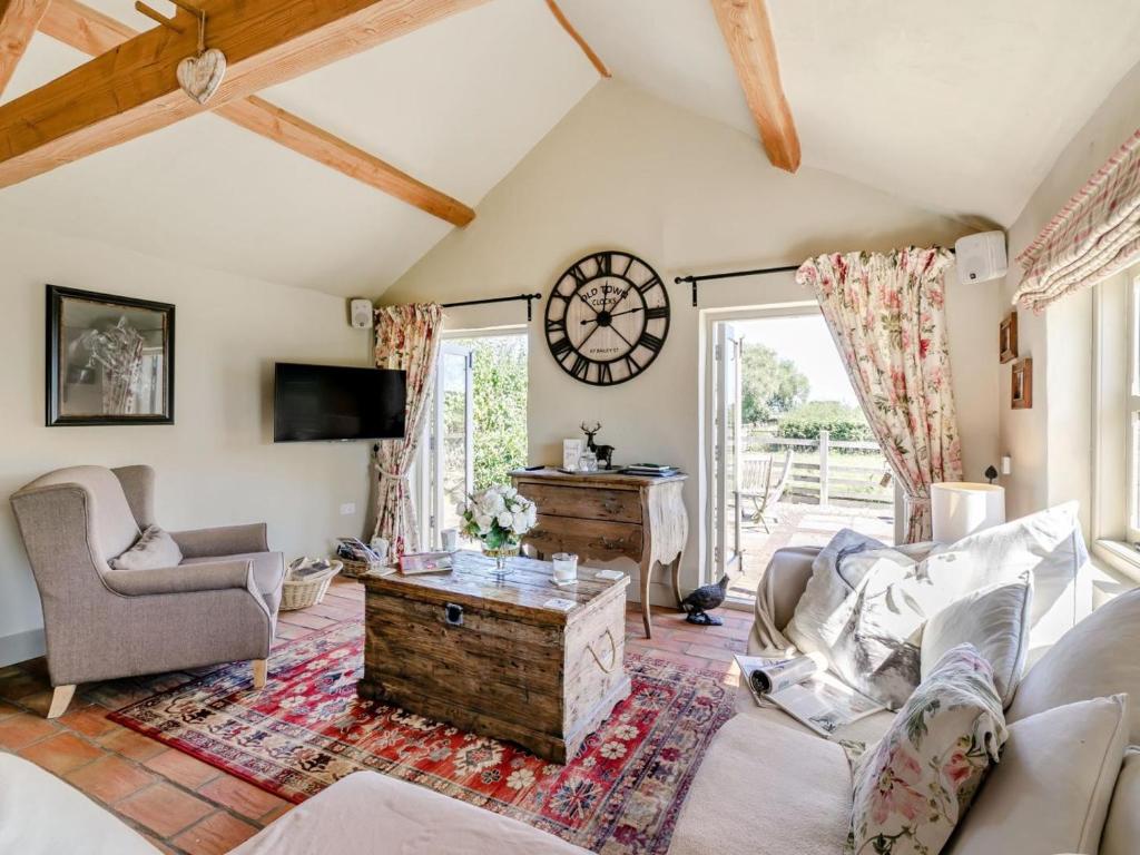 a living room with a couch and a clock on the wall at 2 Bed in York oc-g0073 in Ellerton