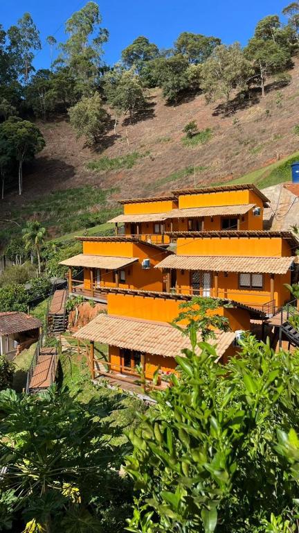 a group of buildings on top of a hill at Vila Florença Chales in Santa Teresa