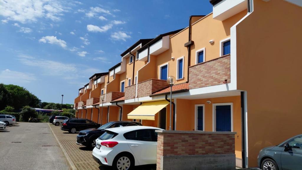 a row of buildings with cars parked in a parking lot at Residence Sole&Mare in Rosapineta