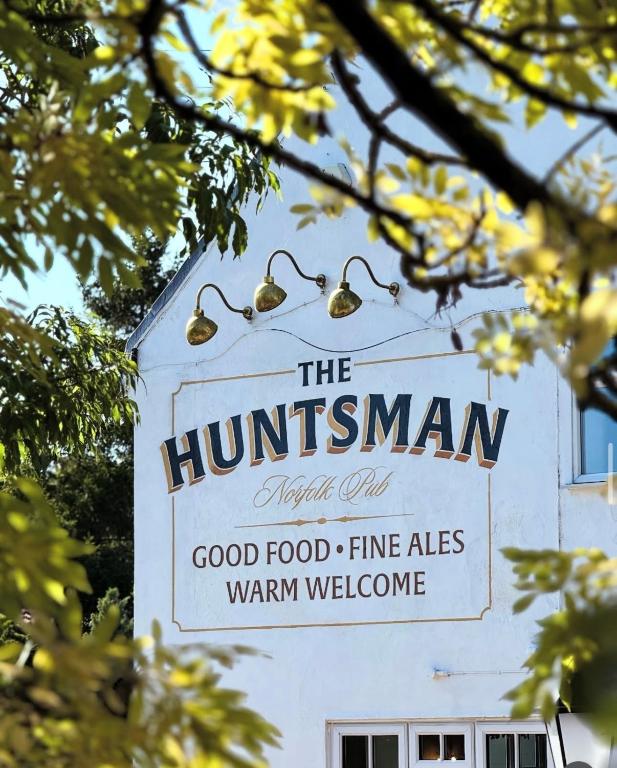 a sign for the hamminsman good food fine ales warm welcome at The Huntsman in Norwich