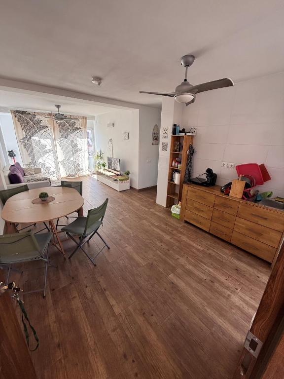 an empty living room with a table and chairs at Casa Alicante Central Apartment with AC 4th floor no elevator in Alicante