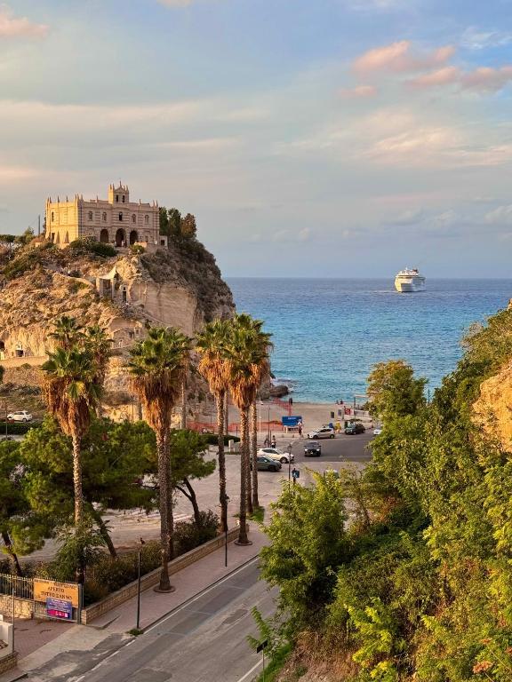 a building on a hill next to the ocean at Casa Vacanze "Pizzo Sorriso Del Mare" in Pizzo