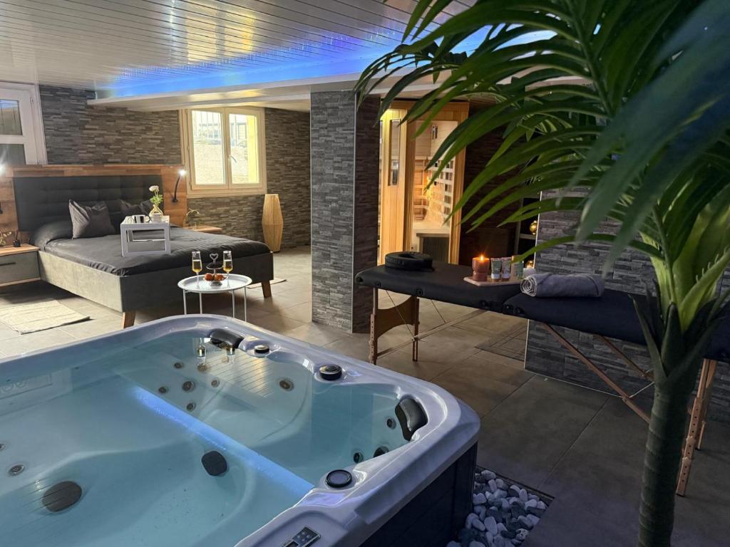 a jacuzzi tub in a living room at Sisters spa room in Portet-sur-Garonne