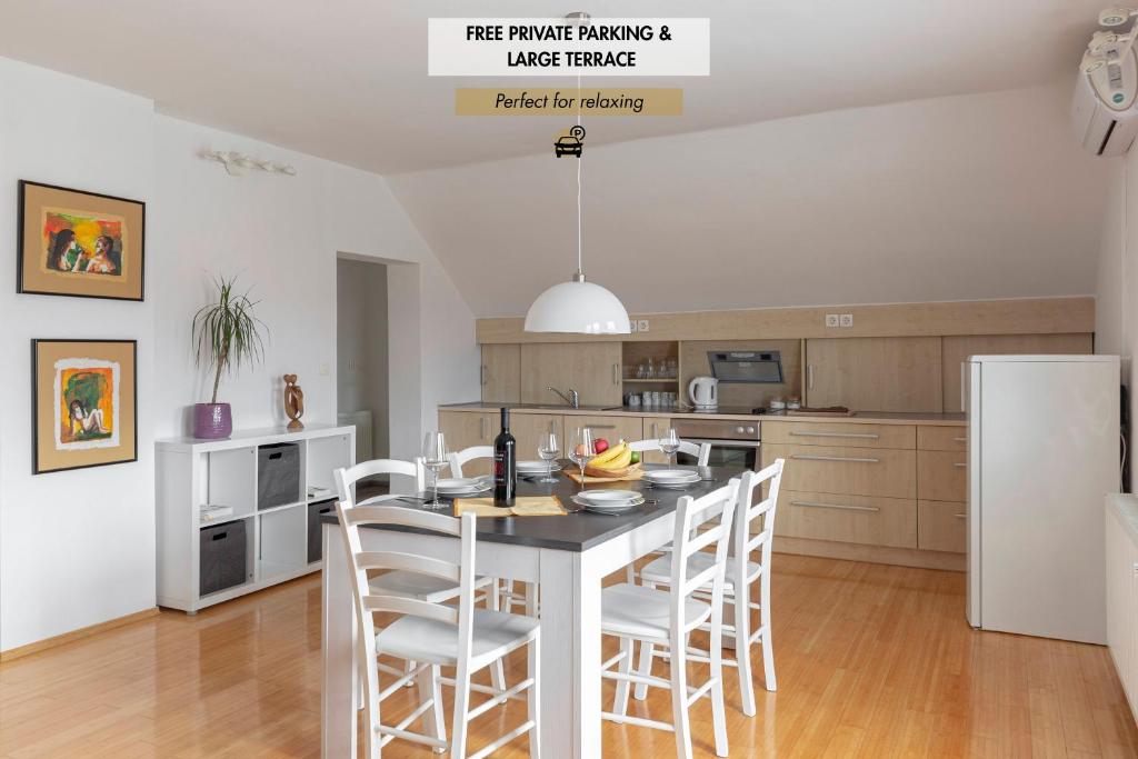 a kitchen with a table and chairs in a room at Apartment Tati in Dol pri Ljubljani