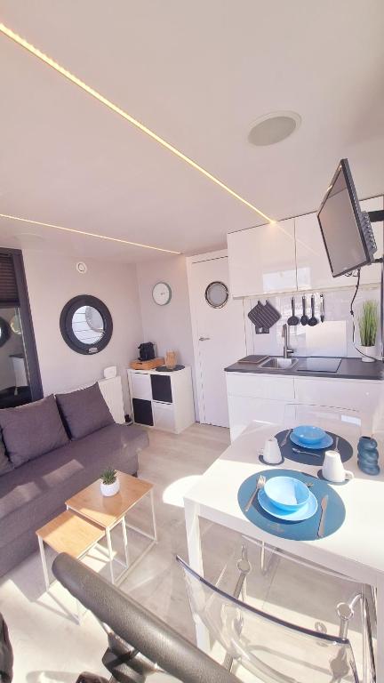 a living room with a couch and a table at Alghero Houseboat Seabreeze 2 in Alghero