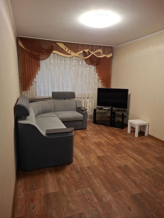 a living room with a couch and a television at Терновской район in Kryvyi Rih