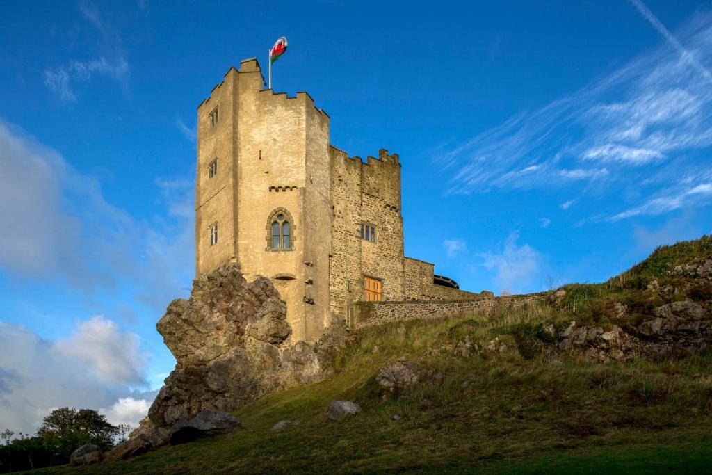 a castle on a hill with a flag on top at Roch Castle in Roch