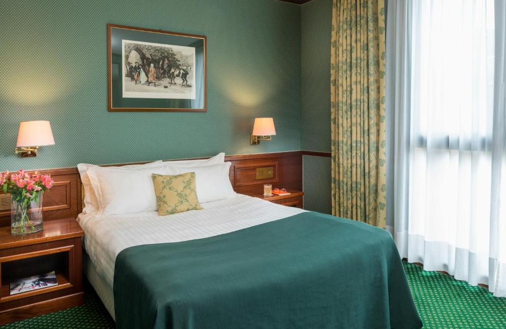 a hotel room with a bed and a window at Leonardo Hotel Milan City Center in Milan