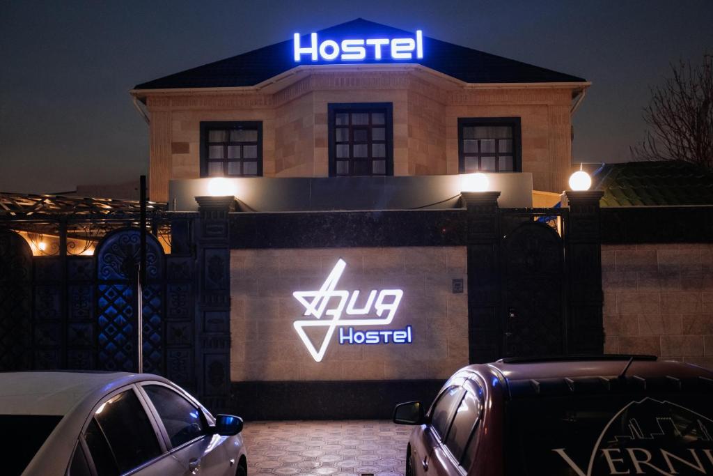 a house with a sign on top of it at Азия Hostel in Shymkent