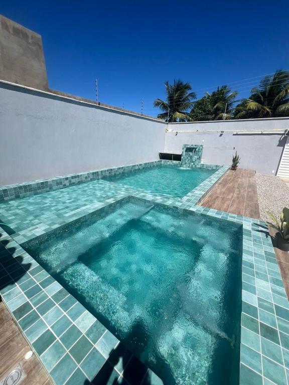 a swimming pool with turquoise water in a house at Casa Massa in Marechal Deodoro