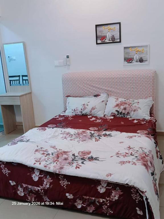 a bedroom with a bed with a red and white blanket at Mesahill Home Stay Nilai in Nilai