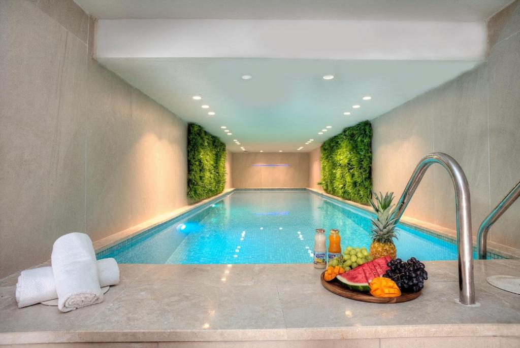 a swimming pool with a bowl of fruit in front of it at Golden Estate - גולדן אסטייט in Safed