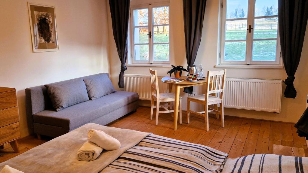 a living room with a couch and a table at Apartmány Včelín in Brniště