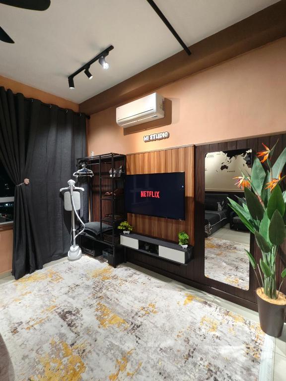 a living room with a television and a fireplace at HI Studio Mesahill Premier - KLIA - Bathtub - WIFI & NETFLIX in Nilai