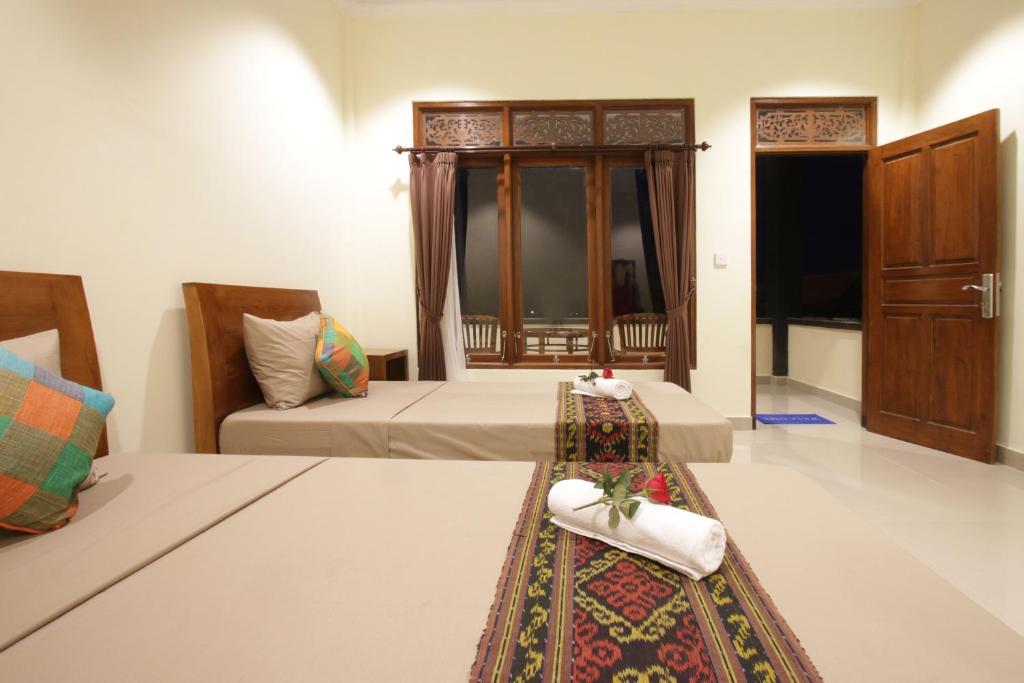 Postel nebo postele na pokoji v ubytování Pondok Wira Ubud