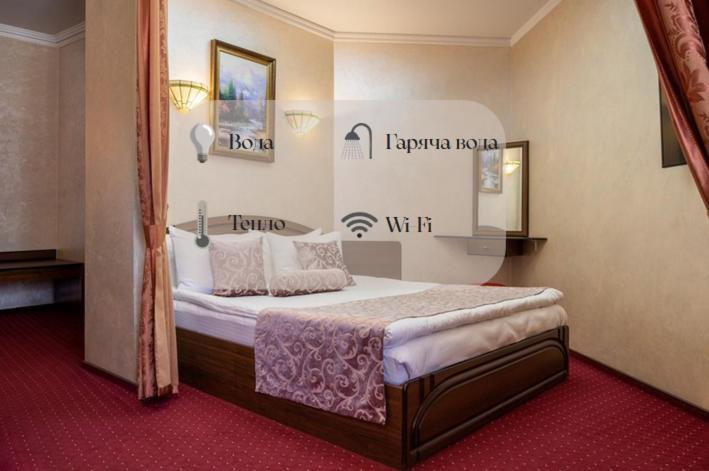 a bedroom with a large bed in a room at Edem Hotel Lviv in Lviv