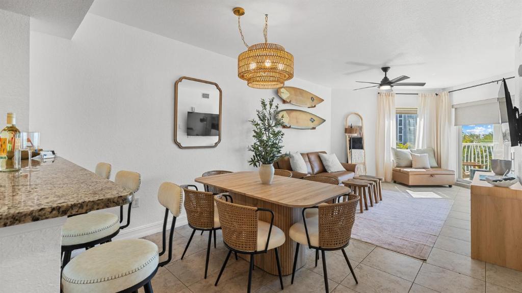a kitchen and living room with a table and chairs at August Beach Escape Special Rates Available! in St. Pete Beach