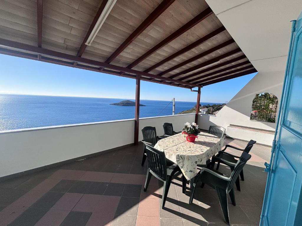 a table on a balcony with a view of the ocean at Sunset Studio Apartments in Kalymnos