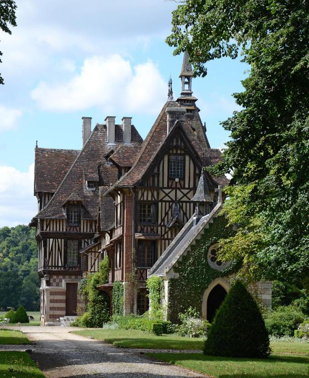 an old house with a turret on a road at Manoir de Villers in Saint-Pierre-de-Manneville