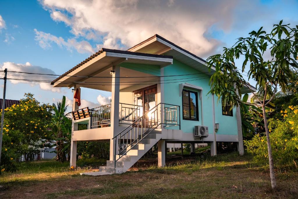 a small blue house with a balcony at Modern Nature Retreat in Ko Phangan