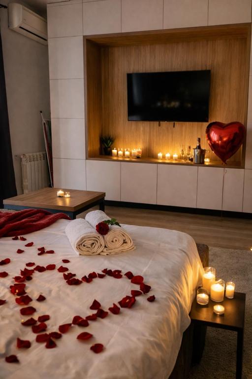 a room with a bed with red roses on it at Iulius Mall Loft in Iaşi