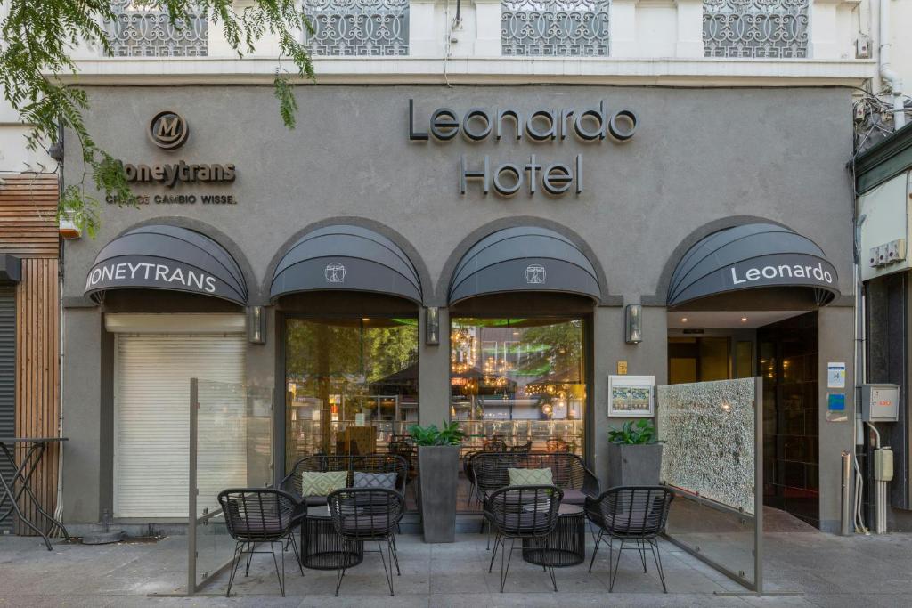 a store front of a furniture store with tables and chairs at Leonardo Hotel Antwerpen in Antwerp