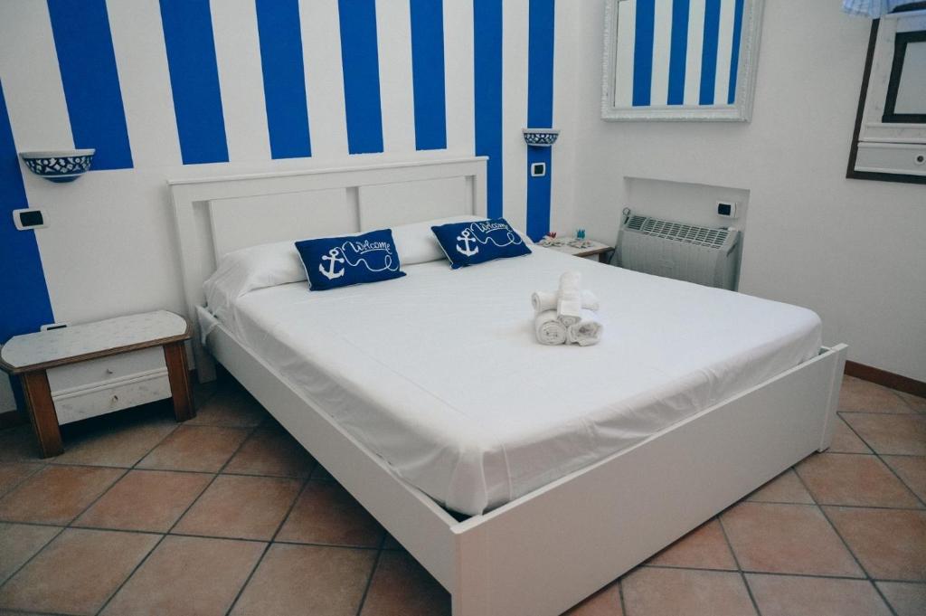 a bedroom with a bed with a stuffed animal on it at Milion's House Apartments in Minori