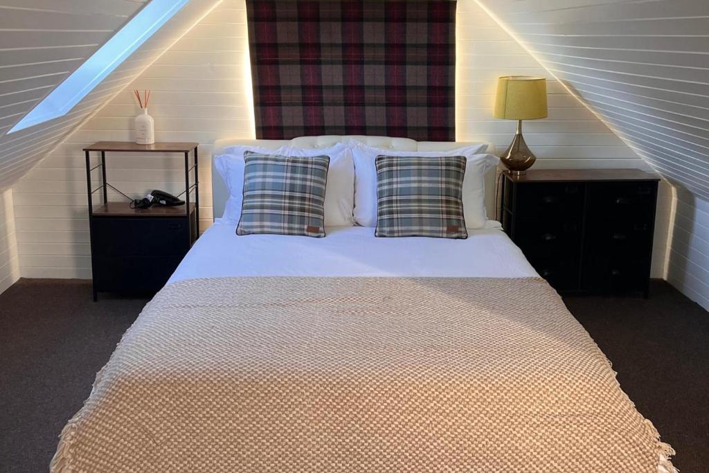 a bedroom with a bed with two pillows at Pets - Garden - Parking - Sleeps up to 4 - Hiking in Banchory