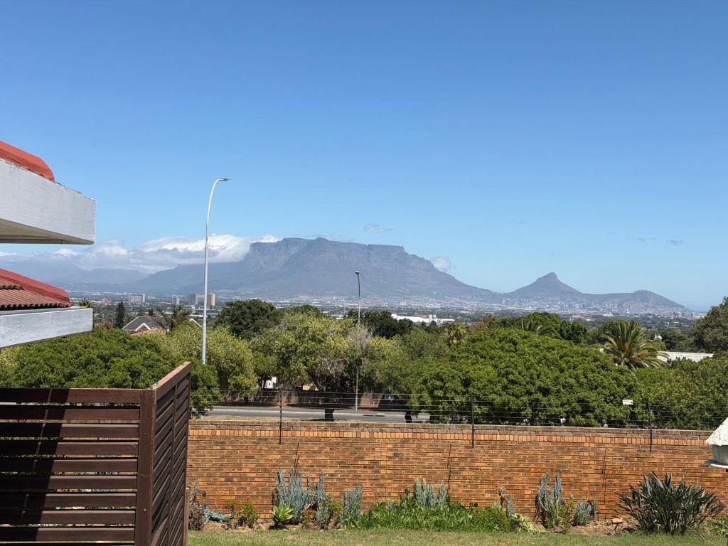 a brick wall with a view of a mountain at Plattekloof Mountain view in Plattekloof