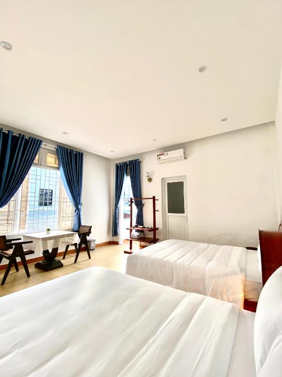 a bedroom with two beds and a piano at New Sala Homestay in Hue