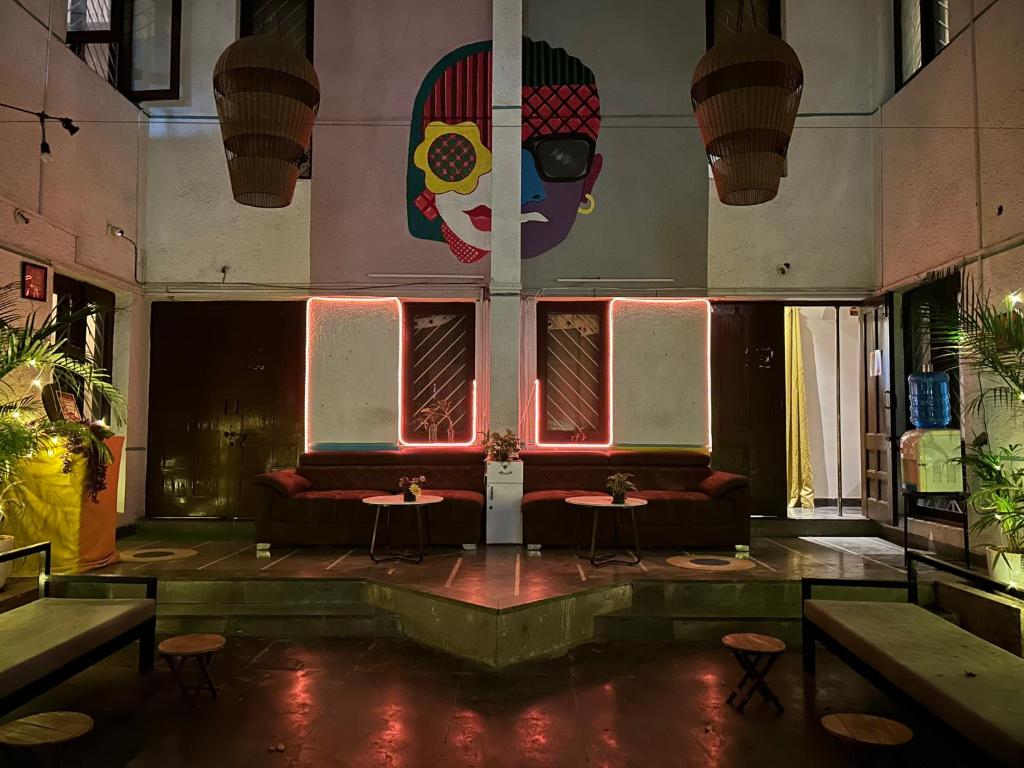 a room with a couch and tables in a building at The Pune Story in Pune