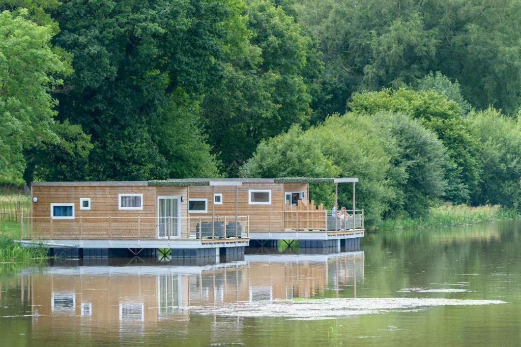 a house on a boat in the middle of a river at TI WAR AN DOUR in Guégon