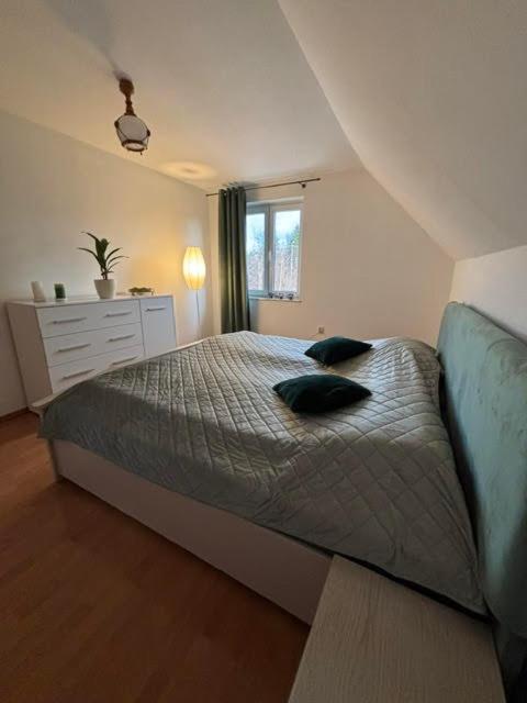 a bedroom with a bed with two pillows on it at Domek nad Sołą in Cisiec