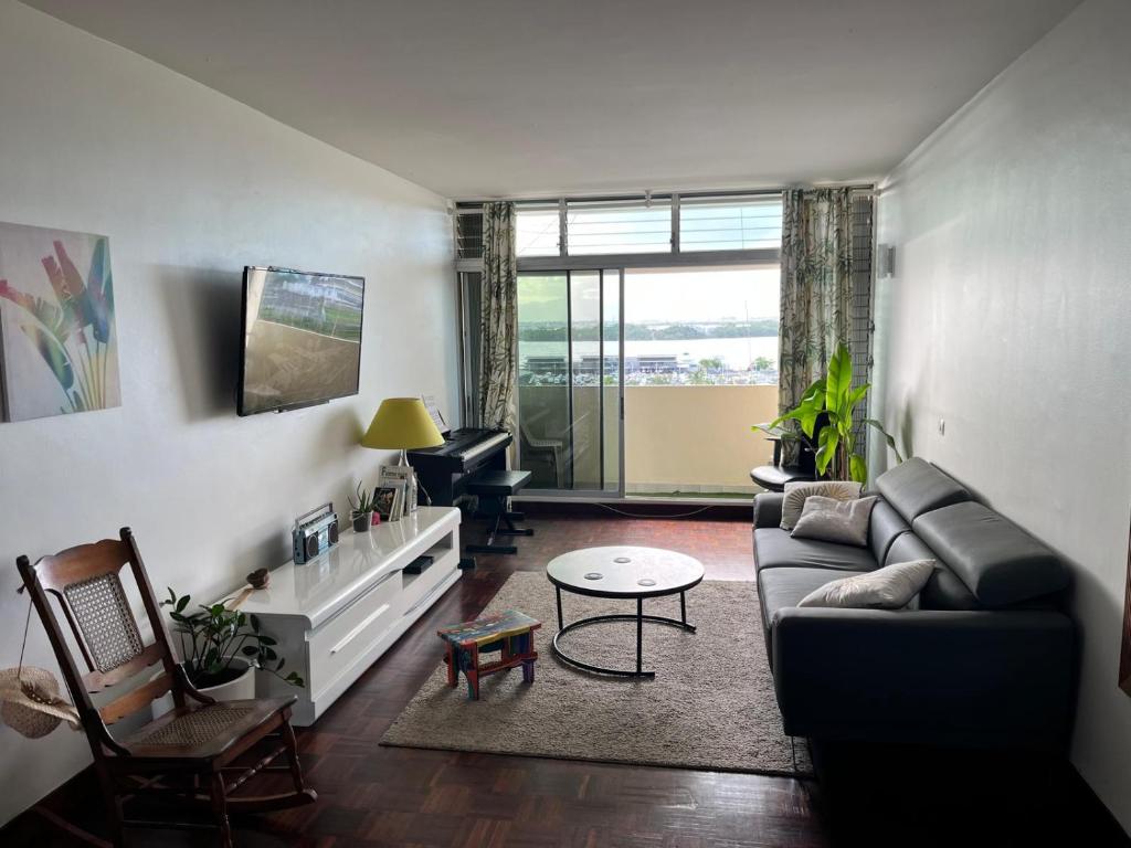 a living room with a couch and a table at Oasis du 7e ciel in Pointe-à-Pitre