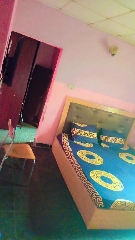 a room with a bed withcriptions on it at Limelight Apartment and suites in Oko Erin