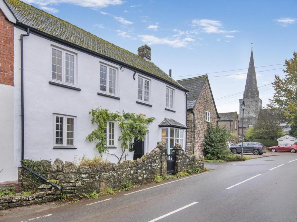 a white house on the side of a street at 3 Bed in Trellech oc-j34206 in Trelleck