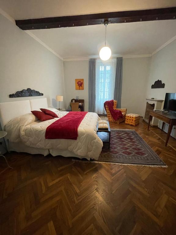 a bedroom with a bed and a living room with a desk at B&B Del Vescovado in Reggio Emilia