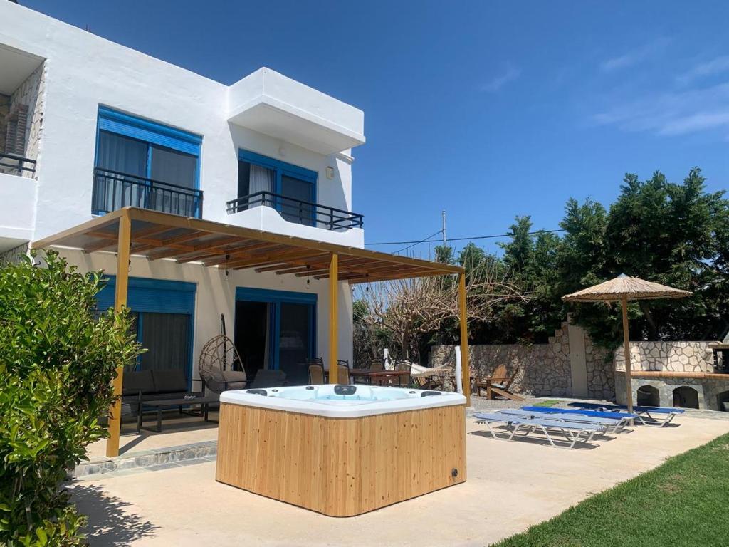 a house with a hot tub in the yard at Seascape Villa in Afantou